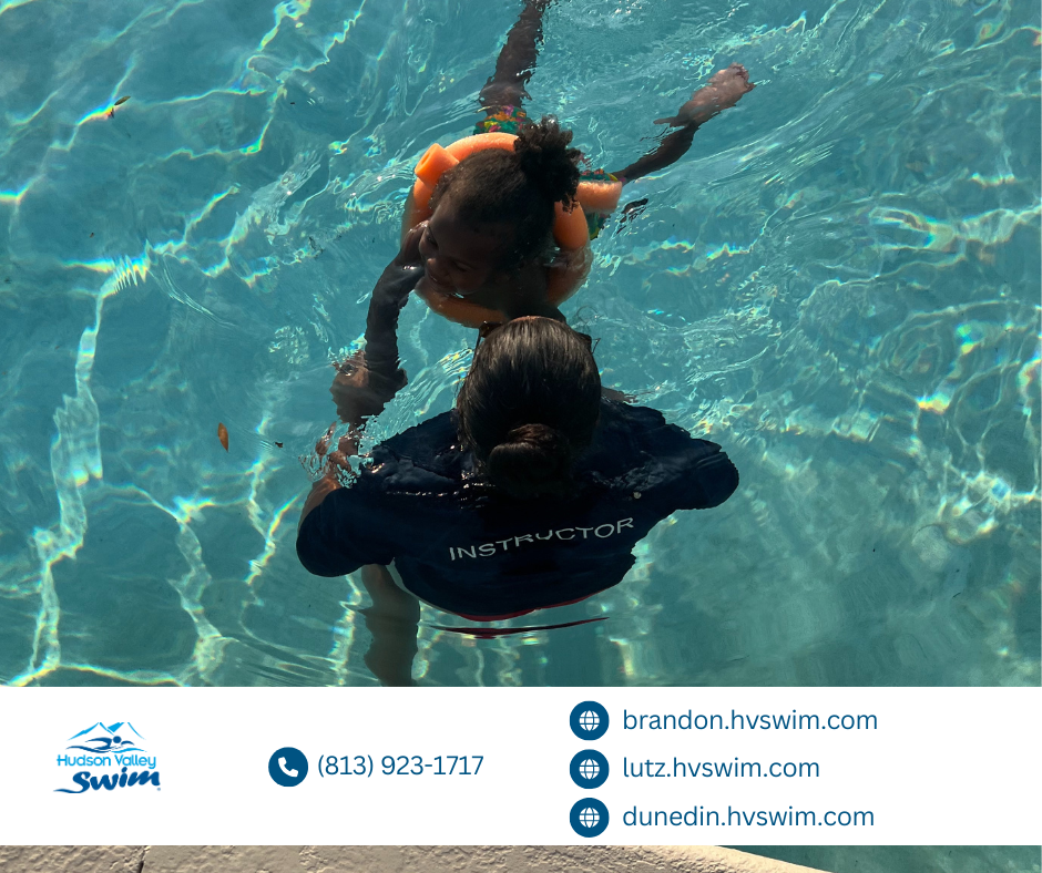 child swimming with instructor