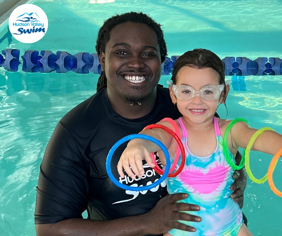 a swim teacher with a student in a pool