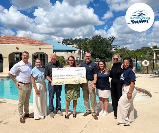 hudson valley swim dunedin with a big check