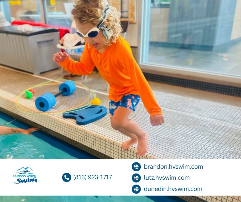 kid jumping into a swimming pool with goggles on