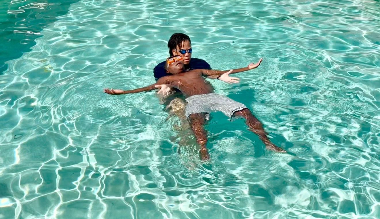 student learning to swim in a pool