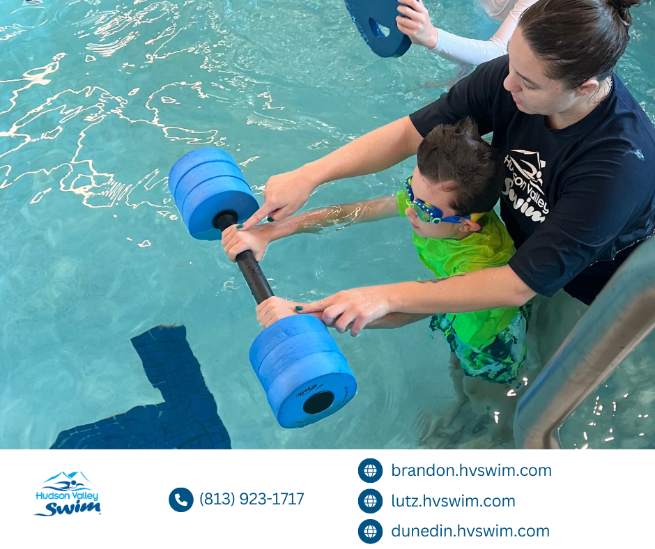 swim teacher showing a kid how to float in water with a floatie bar