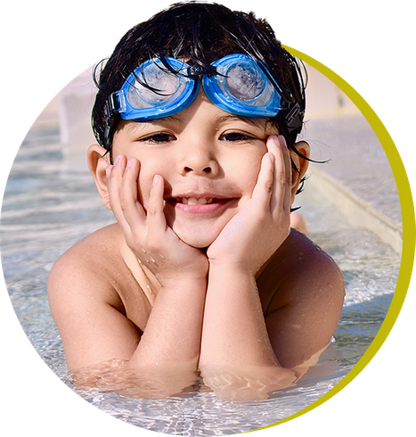 a kid in a pool with goggles on